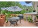 Outdoor deck features an umbrella, dining table, a heater and a barbecue at 2193 Cloverdale Se Dr, Atlanta, GA 30316