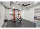 Home gym featuring a squat rack, weights, black rubber floor, and a ping pong table in the next room at 2193 Cloverdale Se Dr, Atlanta, GA 30316