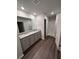 Well-lit bathroom features a double vanity, a large mirror, and a tiled shower at 30 Barton Ln, Covington, GA 30016