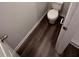 Compact bathroom featuring a toilet and shower with modern flooring at 30 Barton Ln, Covington, GA 30016