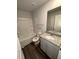 Bright bathroom features a granite countertop, a large mirror, and a white shower-tub combo at 30 Barton Ln, Covington, GA 30016