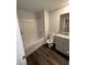 Bright bathroom features a granite countertop, a large mirror, and a white shower-tub combo at 30 Barton Ln, Covington, GA 30016