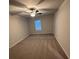 Spacious bedroom with neutral carpet, a ceiling fan, and a window to let in natural light at 30 Barton Ln, Covington, GA 30016