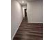 Hallway with luxury vinyl plank flooring and neutral colored walls at 30 Barton Ln, Covington, GA 30016