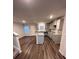 Modern kitchen boasts an island, gray cabinets, granite countertops, and stainless steel appliances at 30 Barton Ln, Covington, GA 30016