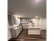 Modern kitchen boasts an island, gray cabinets, granite countertops, and stainless steel appliances at 30 Barton Ln, Covington, GA 30016