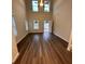 Bright living room features an open-concept design, vaulted ceilings, and stylish wood-look floors at 30 Barton Ln, Covington, GA 30016