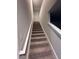 Carpeted stairs lead to the upper level of this home, with white banisters and gray walls at 30 Barton Ln, Covington, GA 30016