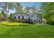 Expansive backyard featuring a lush lawn, mature trees, and a patio area for outdoor enjoyment at 3772 Evans Rd, Atlanta, GA 30340