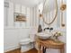 Stylish bathroom featuring a marble bowl sink on a wooden table and gray striped wallpaper at 3772 Evans Rd, Atlanta, GA 30340