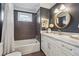 Bathroom featuring a tub/shower combo and a vanity with a marble countertop and round mirror at 3772 Evans Rd, Atlanta, GA 30340