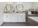 Bathroom featuring a double vanity with marble countertops and a soaking tub at 3772 Evans Rd, Atlanta, GA 30340