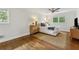 Bedroom with hardwood floors, a ceiling fan, and a window with outdoor views at 3772 Evans Rd, Atlanta, GA 30340