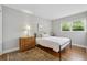 Bedroom with hardwood floors, a single bed, and a dresser by the window at 3772 Evans Rd, Atlanta, GA 30340