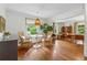 Bright dining area featuring hardwood floors, a modern table and chairs, and views of the outdoors at 3772 Evans Rd, Atlanta, GA 30340