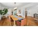 Open dining room with views to the kitchen, hardwood floors, and bright lighting at 3772 Evans Rd, Atlanta, GA 30340
