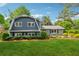 Beautiful home showcasing a well-manicured lawn, mature trees, and picturesque landscaping at 3772 Evans Rd, Atlanta, GA 30340