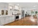Well-appointed kitchen with white cabinets, stainless steel appliances, and hardwood floors at 3772 Evans Rd, Atlanta, GA 30340