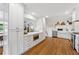 Bright kitchen featuring white cabinets, stainless steel appliances, and hardwood floors at 3772 Evans Rd, Atlanta, GA 30340