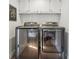 Laundry room features a modern side-by-side washer and dryer set with storage cabinets above at 3772 Evans Rd, Atlanta, GA 30340