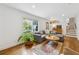 Bright living room featuring hardwood floors, a comfortable sofa, and a view of the outdoors at 3772 Evans Rd, Atlanta, GA 30340