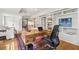 Comfortable living room featuring custom built-in bookshelves, a desk and rug at 3772 Evans Rd, Atlanta, GA 30340