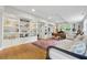 Bright living room offers hardwood floors, custom bookshelves and a daybed sofa at 3772 Evans Rd, Atlanta, GA 30340