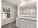 Bathroom featuring double vanity with granite countertop and a large mirror at 8230 Coldstream Dr, Fairburn, GA 30213