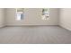 Spacious bedroom with two bright windows and plush neutral carpeting at 8230 Coldstream Dr, Fairburn, GA 30213