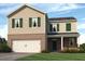 Charming two-story home featuring brick accents, green shutters, and a two-car garage at 8230 Coldstream Dr, Fairburn, GA 30213