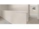Hallway with neutral walls and carpeting leading to bedrooms and bathrooms at 8230 Coldstream Dr, Fairburn, GA 30213
