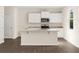 Bright kitchen with white cabinets, stainless steel appliances, and a center island at 8230 Coldstream Dr, Fairburn, GA 30213