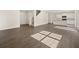 Bright, open-concept living space with wood floors and a kitchen in the background at 8230 Coldstream Dr, Fairburn, GA 30213