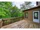 Wooden deck ideal for relaxation, offering views of the natural backyard landscaping and mature trees at 1523 Fallen Leaf Dr, Marietta, GA 30064