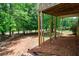 View of the backyard featuring a covered porch, natural landscaping, and mature trees at 1523 Fallen Leaf Dr, Marietta, GA 30064