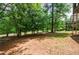 Spacious backyard with lush greenery, mature trees, and natural landscaping at 1523 Fallen Leaf Dr, Marietta, GA 30064