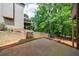 A backyard view featuring trees, the home's exterior, and a partial wooden fence at 1523 Fallen Leaf Dr, Marietta, GA 30064