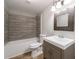 Bathroom featuring a tub and shower, grey wood-look tile, and grey vanity at 1523 Fallen Leaf Dr, Marietta, GA 30064