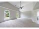 Large bedroom with vaulted ceiling, neutral walls and carpet, plus windows overlooking mature trees at 1523 Fallen Leaf Dr, Marietta, GA 30064