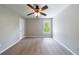 Bright bedroom featuring neutral walls, carpeting and a ceiling fan with light fixture at 1523 Fallen Leaf Dr, Marietta, GA 30064