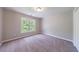 Cozy bedroom features plush carpet, light walls, and a window with wooded view at 1523 Fallen Leaf Dr, Marietta, GA 30064
