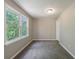 Bedroom featuring neutral paint and windows with a treed exterior view at 1523 Fallen Leaf Dr, Marietta, GA 30064