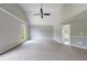 A bedroom features neutral walls, carpet, ceiling fan, and an open doorway to an adjacent bathroom at 1523 Fallen Leaf Dr, Marietta, GA 30064
