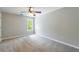 Spacious bedroom with neutral walls, plush carpeting and a ceiling fan with light at 1523 Fallen Leaf Dr, Marietta, GA 30064