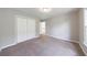 Bedroom featuring neutral walls, carpeting, closet and staircase access to second floor at 1523 Fallen Leaf Dr, Marietta, GA 30064