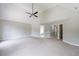 A bedroom features neutral walls, carpet, ceiling fan, and access to bathrooms and other rooms at 1523 Fallen Leaf Dr, Marietta, GA 30064