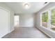 Well-lit bedroom showcasing plush carpet, closet, staircase, and a view of the woods at 1523 Fallen Leaf Dr, Marietta, GA 30064