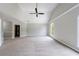 Expansive bedroom offers plush carpeting, arched windows for natural light, and modern ceiling fan at 1523 Fallen Leaf Dr, Marietta, GA 30064