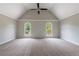 Spacious bedroom with vaulted ceiling, neutral carpet and two arched windows letting in natural light at 1523 Fallen Leaf Dr, Marietta, GA 30064