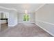 Elegant dining room featuring a crystal chandelier, plush carpet, and wainscoting at 1523 Fallen Leaf Dr, Marietta, GA 30064